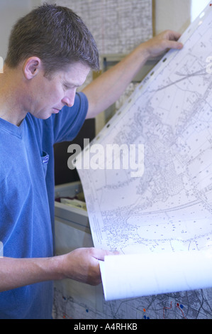 man studying a detailed map of his local area Stock Photo - Alamy