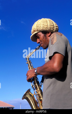 Young man playing a saxophone at Grand Riviere Fishing village in the northern tip of Martinique Stock Photo