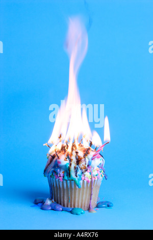 Birthday cupcake burned and melted by out of control candle flames Stock Photo