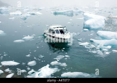 Boat among ice blocks, Sermilik Fjord, East Greenland Stock Photo