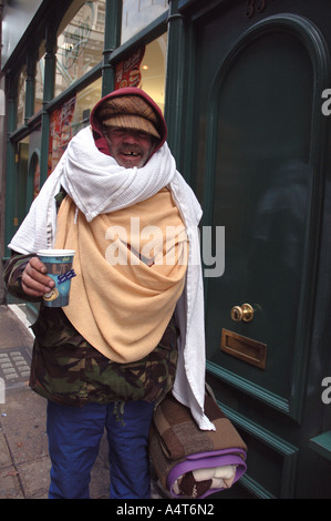 Homeless older man begging in the streets of London. Stock Photo