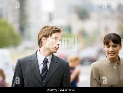 Businessman and woman chatting together Stock Photo