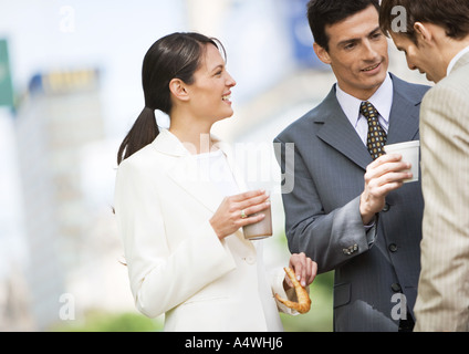 Business colleagues having coffee outdoors Stock Photo
