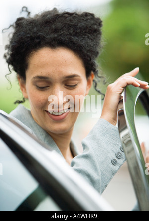 Businesswoman getting into car Stock Photo