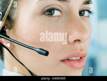 Woman wearing headset, close-up Stock Photo