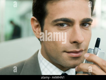 Businessman holding cell phone near face Stock Photo