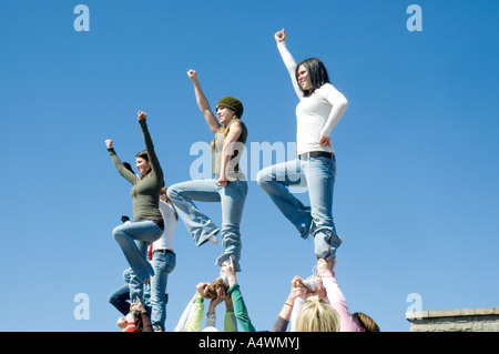 Young ladies mimicking the Statue of Liberty on Liberty Island in New York Stock Photo