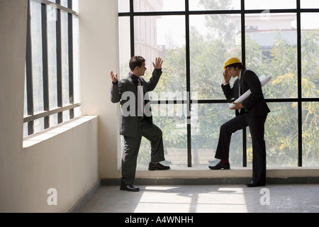 Businessmen talking in an unfinished room Stock Photo
