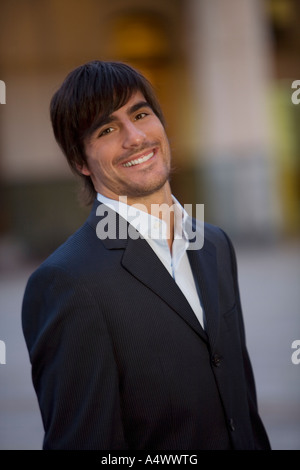 Man wearing a suit in courtyard Stock Photo