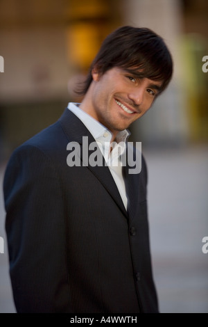 Man wearing a suit in courtyard Stock Photo