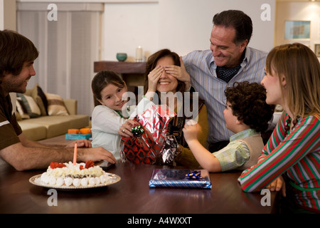 Middle-aged woman opening birthday presents Stock Photo