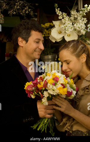 Couple exchanging a bouquet of flowers Stock Photo