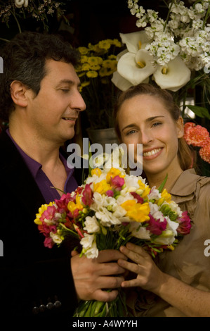 Couple exchanging a bouquet of flowers Stock Photo