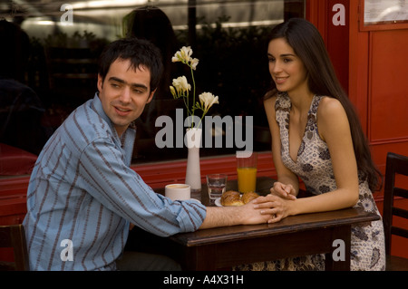 Couple having breakfast at an outdoor cafe Stock Photo