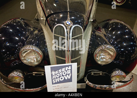 Sign with the logotype of Essen Motor Show in front of a oldtimer BMW Cabriolet 1938 model, NRW, Germany Stock Photo