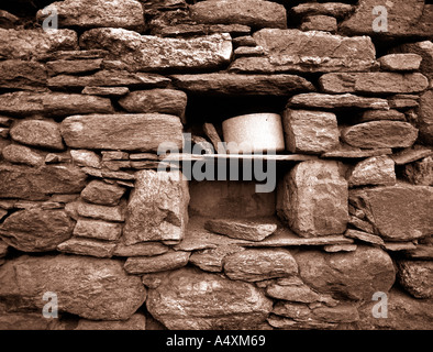 Tin cup in niche in wall of abandoned former croft house at Westafirth island of Yell Shetland northern Scotland Stock Photo