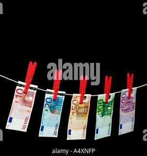 Euro Notes Hanging on a Clothesline Against a Black Background Stock Photo