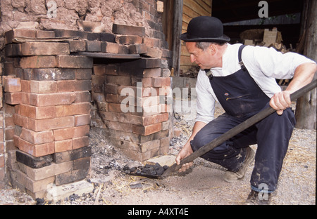 Colin Richards making bricks by hand setting the fie in the kiln Stock Photo