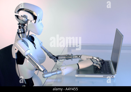 Female humanoid robot operating a laptop computer Stock Photo