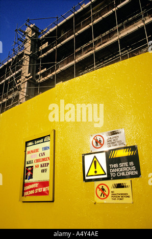 Safety signs on construction site wall warning children of danger Cardiff UK Stock Photo