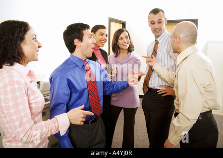 Group of co-workers talking in office Stock Photo