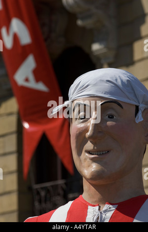 Male gigante (giant) during parade with hankie on head wearing football shirt, Aste Nagusia fiesta,  Plaza Arriaga, Bilbao Stock Photo