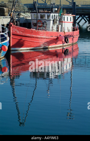 dh Stromness Harbour STROMNESS ORKNEY Red hulled converted trawler diving boat at quayside dive reflect Stock Photo