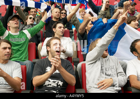 Female fan singing at football match Stock Photo - Alamy