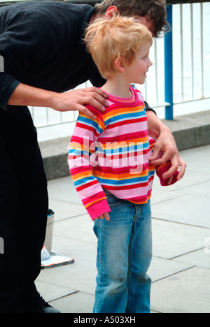 Boy watching a busker on the South Bank London Stock Photo - Alamy