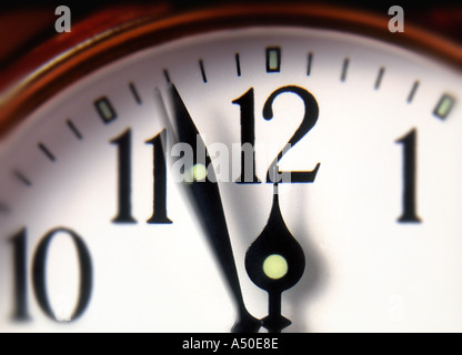 clock hands moving towards twelve o clock Stock Photo