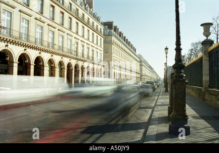 Cars - automobiles - zoom down a busy french street.  Cars - autos create motion blur in France - Europe during daytime / daylight hours Stock Photo