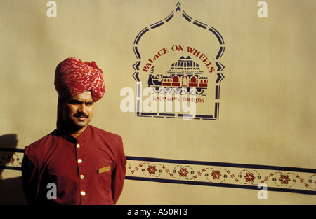 An attendant next to the palace on wheels A luxury train in J Stock Photo