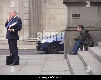 Businessman mobile phone man sitting on steps London Stock Photo