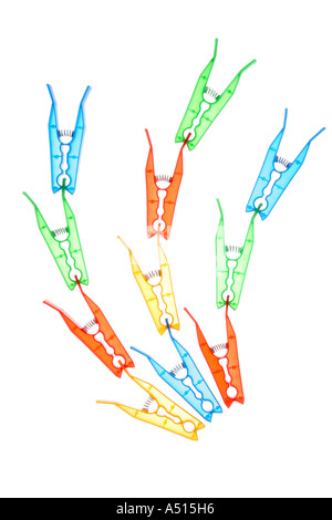 Clothes pegs back-lit on a translucent background. Stock Photo