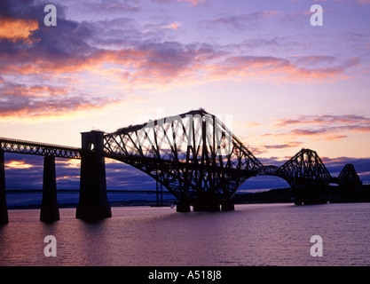 Historical Victorian Scotland Firth of Forth steel cantilever rail bridge in silhouette at sunset South Queensferry view towards North Queensferry UK Stock Photo