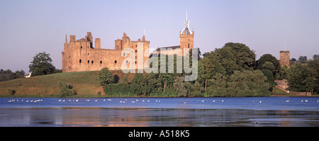 Linlithgow Loch the ruined Palace with the tower of St Michaels Church beyond Stock Photo
