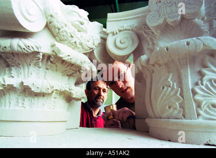Training a young craftsman to become a stonemason Stock Photo