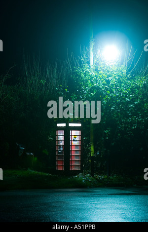 a telephone box under a street lamp in a remote Suffolk village of Great Livermere, UK Stock Photo