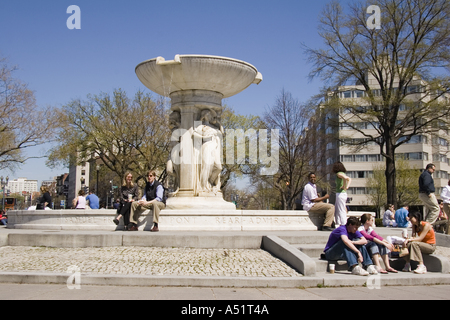 People sitting around the fountain in DuPont Circle on Massachusetts Avenue Washington DC USA Stock Photo