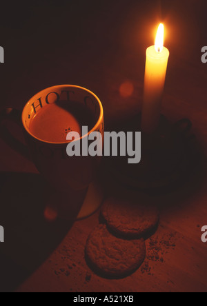 Hot Chocolate and Biscuits lit by Candle (Medium Format) Stock Photo