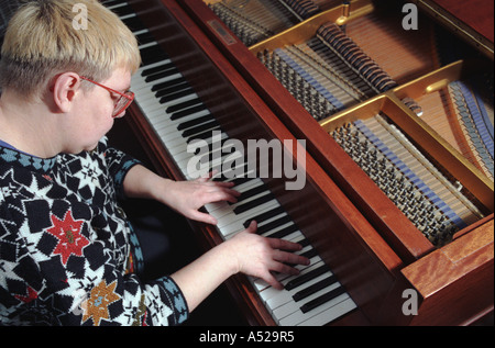 Woman playing the piano Stock Photo