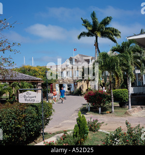 Couple walk at old restored Copper and Lumber Store hotel in Nelsons Dockyard at English Harbour Antigua The Caribbean Stock Photo