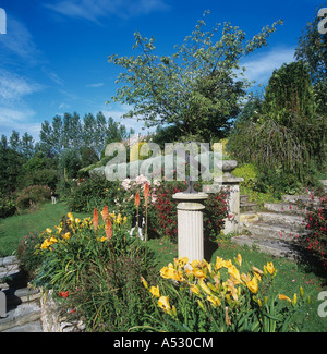 Flowers steps features in terraces in a sloping Devon garden in summer Stock Photo