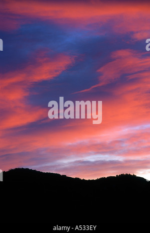Brilliant sunset clouds over mountain ridges Stock Photo