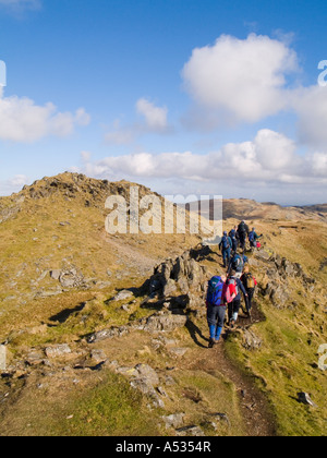 Group of walkers on Cnicht mountain summit ridge heading north east in Snowdonia 'National Park' North Wales UK Stock Photo