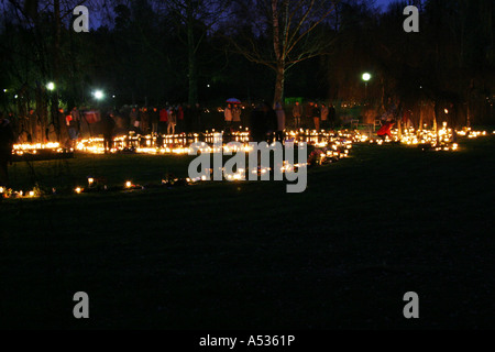 Candles around a memorial grave at a graveyard in Sweden at all saints day. The first sunday of november every year Stock Photo