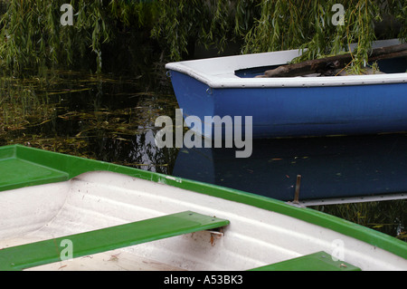 Two rowboats under a weeping willow in the water Stock Photo
