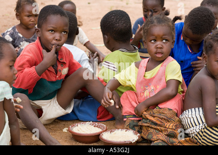 Hungry children eating phala as part of the Joseph Project feeding programme in the village of Buli, Malawi, Africa Stock Photo