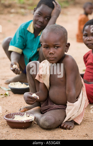 Hungry children eating phala as part of the Joseph Project feeding programme in the village of Buli, Malawi, Africa Stock Photo