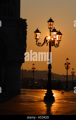 Lamp post next to the Doges Palace in St Marks Square at sunrise dawn morning Venice Italy Stock Photo